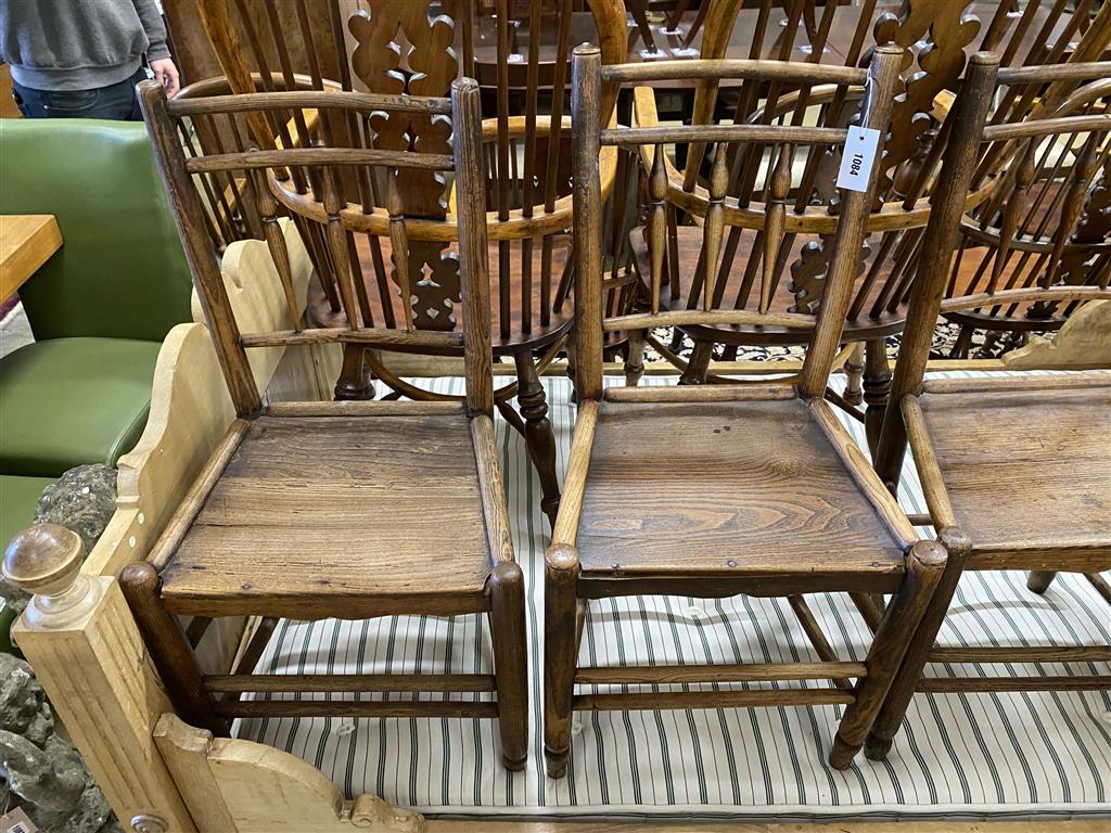A set of four 19th century provincial ash and elm wood seat dining chairs
